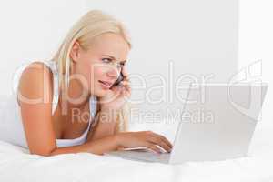 Blonde woman on the phone using a notebook
