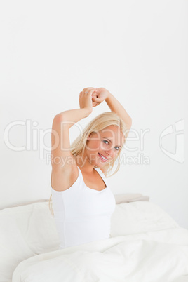 Portrait of a cute woman stretching her arms