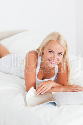 Portrait of a smiling woman with a magazine