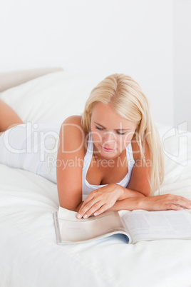 Portrait of a cute woman reading magazine