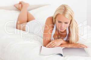 Cute woman reading magazine