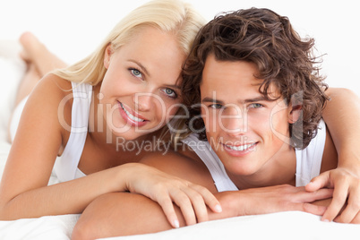 Couple lying on their bed