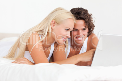 Cute couple using a laptop