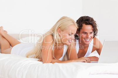 Smiling couple using a notebook