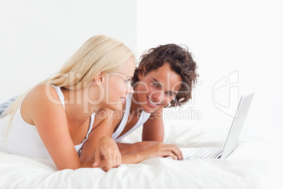 Portrait of a lovely couple using a laptop