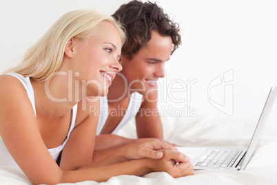Lovely couple using a laptop