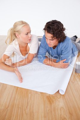 Portrait of a woman showing a point on a plan to her fiance