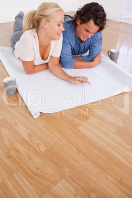 Portrait of a couple looking at their future room on a plan