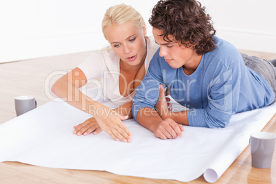 Couple looking at their future room on a plan