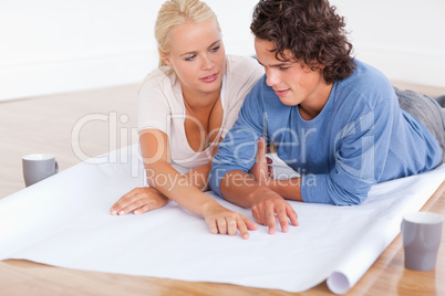 Couple talking about their future room with a plan