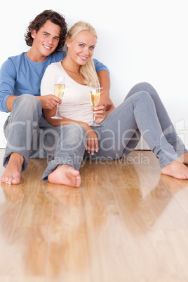 Portrait of a cute couple with glasses of sparkling wine
