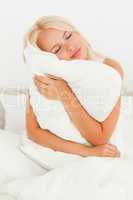 Blonde woman holding a pillow