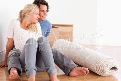 Lovely couple sitting on the floor