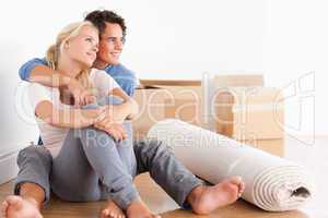 Smiling couple sitting on the floor