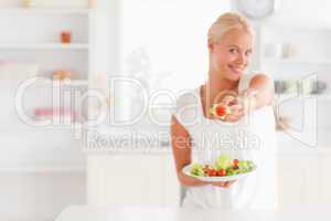 Woman giving a tomato