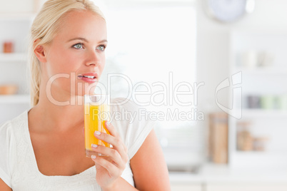 Close up of a woman drinking orange juice