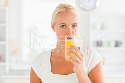 Blonde woman drinking juice