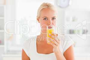 Blonde woman drinking juice