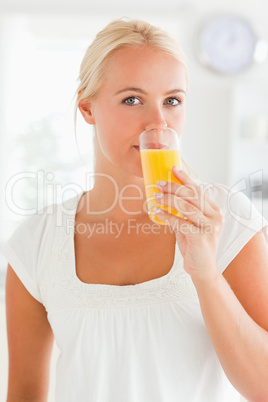 Portrait of a woman drinking orange juice