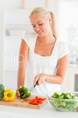 Cute woman slicing pepper