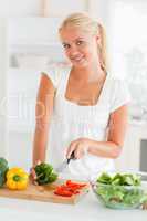 Lovely woman slicing pepper