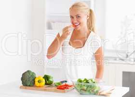 Woman eating pepper