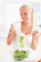 Portrait of a woman mixing a salad