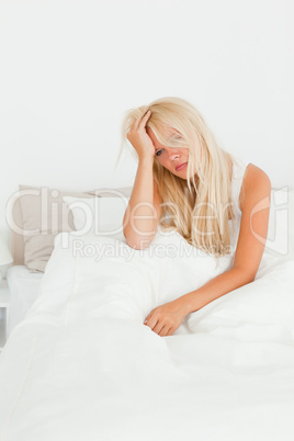 Portrait of a beautiful woman sitting on her bed