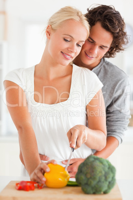 Portrait of a couple slicing pepper
