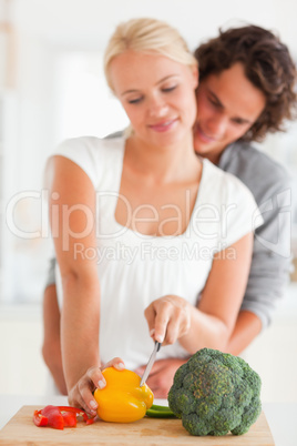 Portrait of a young couple slicing pepper