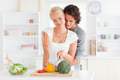 Young couple slicing pepper