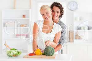 Lovely couple slicing pepper