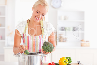 Woman putting cabbage on boiling water