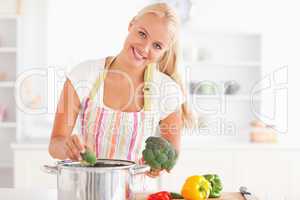 Woman putting cabbage on water