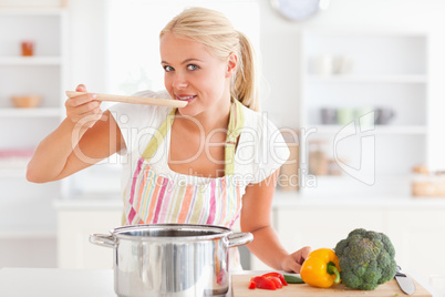 Blonde woman tasting her meal
