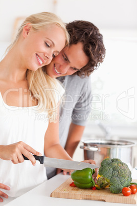 Portrait of a couple chopping pepper