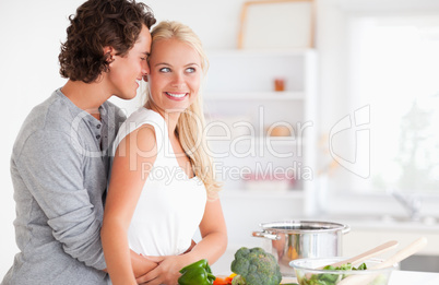 Couple hugging while cooking
