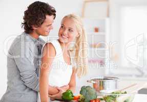Lovely couple hugging while cooking