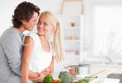 In love couple hugging while cooking