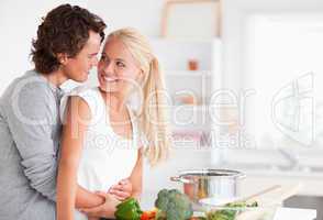 In love couple hugging while cooking