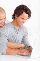 Portrait of a cute couple using a laptop