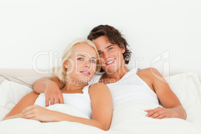 Couple posing in their bedroom