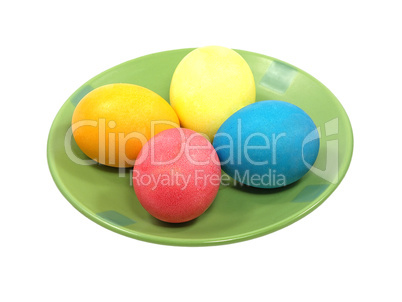 Multicolored eggs on a green plate.