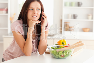 Woman telephoning in kitchen