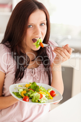 Woman eating salad