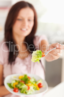 A woman offers salad