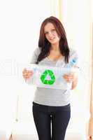 Woman showing recycling bin