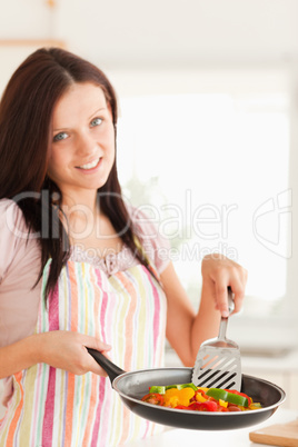 Woman frying vegetables