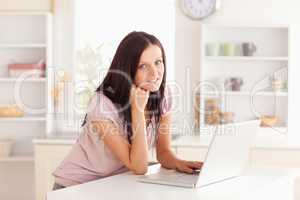 Woman at laptop in kitchen