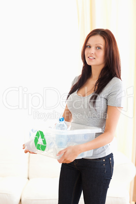 Woman holding a recycling bin